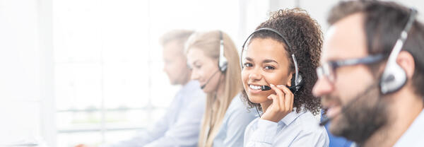 Bild vergrößern: Call,Center,Worker,Accompanied,By,Her,Team.,Smiling,Customer,Support